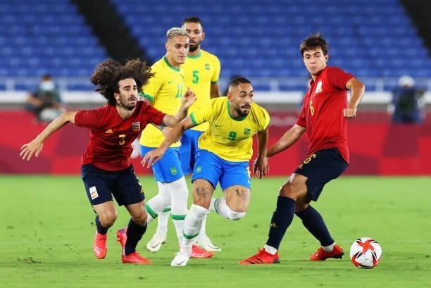Matheus Cunha of Team Brazil breaks past Marc Cucurella and Martin Zubimendi of Team Spain during the Men's Gold Medal Match between Brazil and Spain...