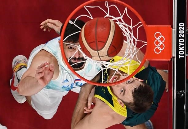 Ziga Dimec of Team Slovenia and Nic Kay of Team Australia watch the ball go into the basket during the first half of the Men's Basketball Bronze...