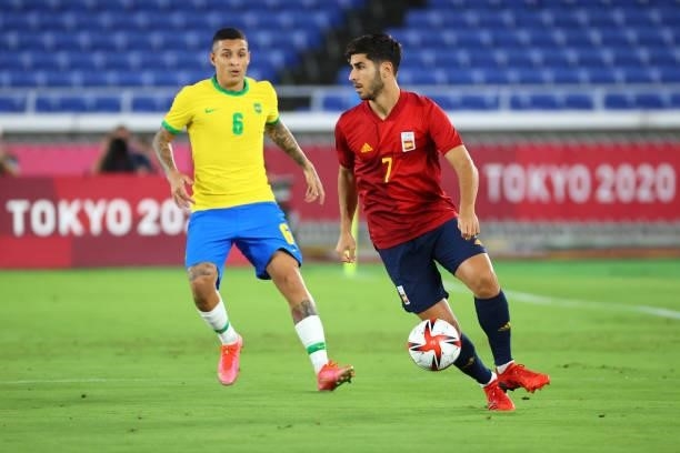 Marco Asensio of Team Spain controls the ball against Guilherme Arana of Team Brazil in the first half during the men's gold medal match between Team...