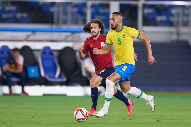 Matheus Cunha of Brazil runs with the ball under pressure from Marc Cucurella of Spain during the Men's Gold Medal Match between Brazil and Spain on...