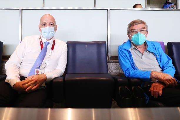 Gianni Infantino, President of FIFA and Thomas Bach, President of the International Olympic Committee wear face masks as they pose for a photograph...