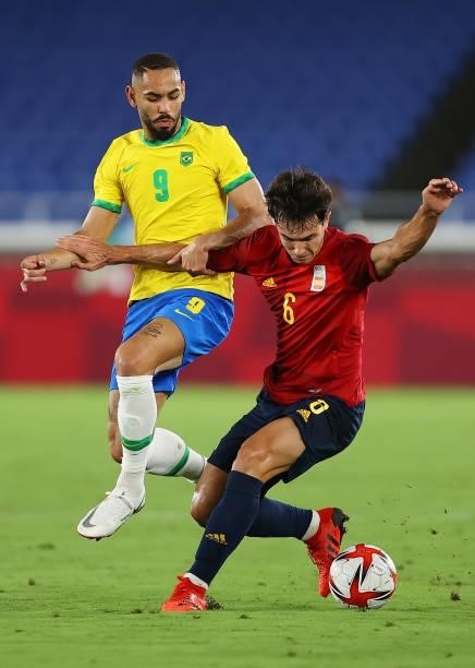 Martin Zubimendi of Team Spain is challenged by Matheus Cunha of Team Brazil during the Men's Gold Medal Match between Brazil and Spain on day...