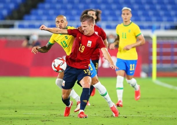 Dani Olmo of Team Spain battles for possession with Dani Alves of Team Brazil during the Men's Gold Medal Match between Brazil and Spain on day...