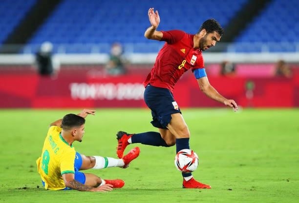 Mikel Merino of Team Spain is challenged by Bruno Guimaraes of Team Brazil during the Men's Gold Medal Match between Brazil and Spain on day fifteen...