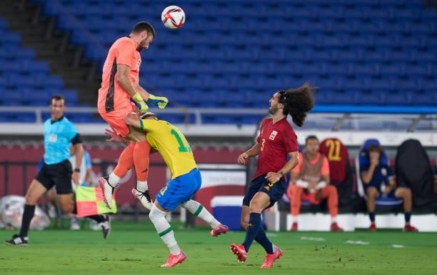 Antony Matheus of Team Brazil competes for the ball with Unai Simon of Team Spain during the Men's Gold Medal Match between Brazil and Spain on day...