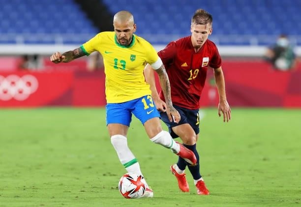 Dani Alves of Team Brazil makes a pass whilst under pressure from Dani Olmo of Team Spain during the Men's Gold Medal Match between Brazil and Spain...