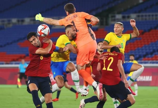 Matheus Cunha of Team Brazil is fouled by Unai Simon of Team Spain leading to a penalty being awarded during the Men's Gold Medal Match between...