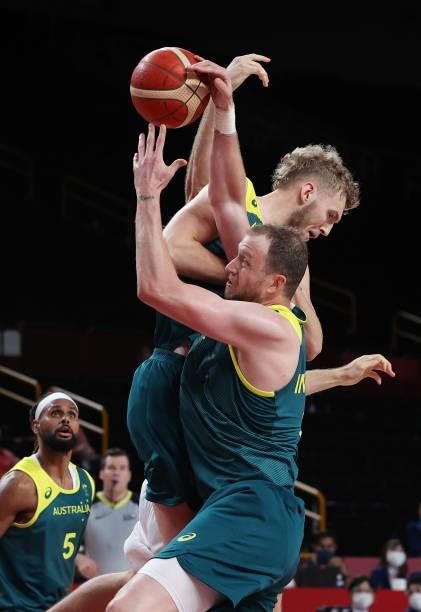 Joe Ingles of Team Australia and teammate Jock Landale crash into one another while trying to grab a rebound against Team Slovenia during the second...