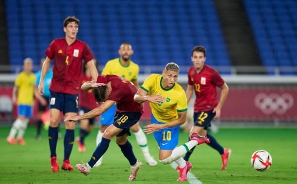 Richarlison De Andrade of Team Brazil competes for the ball with Oscar Garcia of Spain during the Men's Gold Medal Match between Brazil and Spain on...