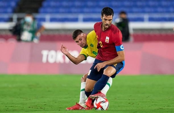 Bruno Guimaraes of Team Brazil competes for the ball with Mikel Merino of Team Spain during the Men's Gold Medal Match between Team Brazil and Team...