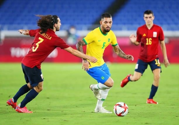 Luiz Douglas of Team Brazil battles for possession with Marc Cucurella of Team Spain during the Men's Gold Medal Match between Brazil and Spain on...