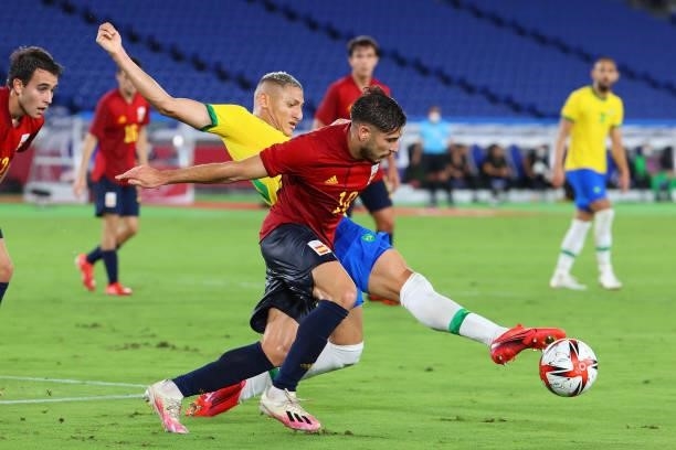 Richarlison of Team Brazil and Oscar Gil of Team Spain battle for possession in the first half during the men's gold medal match between Team Brazil...