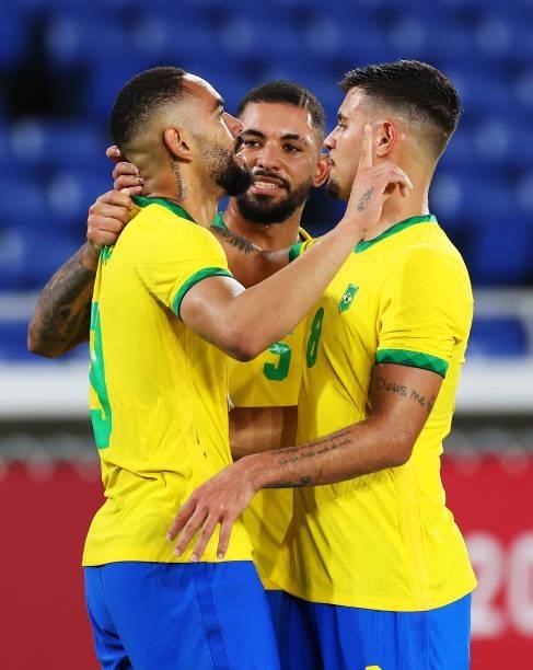Matheus Cunha of Team Brazil celebrates with Luiz Douglas and Bruno Guimaraes after scoring their side's first goal during the Men's Gold Medal Match...