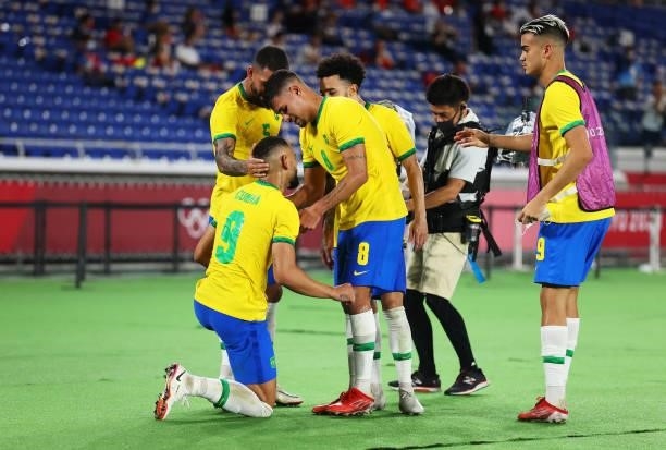 Matheus Cunha of Team Brazil celebrates with Luiz Douglas and Bruno Guimaraes after scoring their side's first goal during the Men's Gold Medal Match...