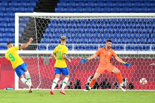 Matheus Cunha of Team Brazil scores their side's first goal past Unai Simon of Team Spain during the Men's Gold Medal Match between Brazil and Spain...
