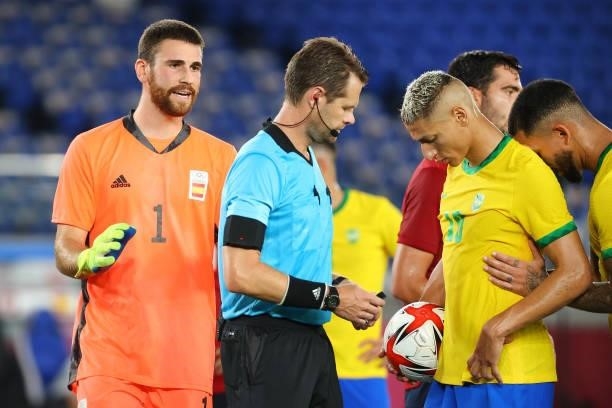 Unai Simon of Team Spain argues with the referee after issuing a penalty kick to Richarlison of Team Brazil in the first half during the men's gold...
