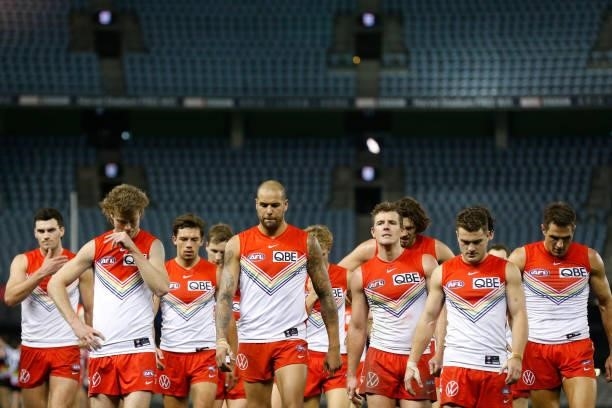 Dejected Sydney Swans players walk from the ground after the round 21 AFL match between St Kilda Saints and Sydney Swans at Marvel Stadium on August...