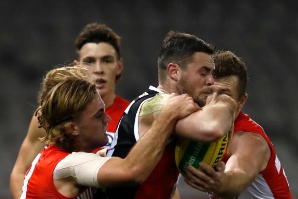 James Rowbottom and Luke Parker of the Swans tackle Brad Crouch of the Saints during the round 21 AFL match between St Kilda Saints and Sydney Swans...