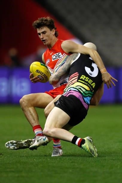 Zac Jones of the Saints tackles Sam Wicks of the Swans during the round 21 AFL match between St Kilda Saints and Sydney Swans at Marvel Stadium on...