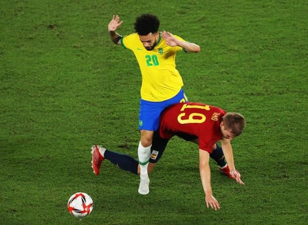 Dani Olmo of Team Spain is challenged by Claudinho of Team Brazil during the Men's Gold Medal Match between Brazil and Spain on day fifteen of the...