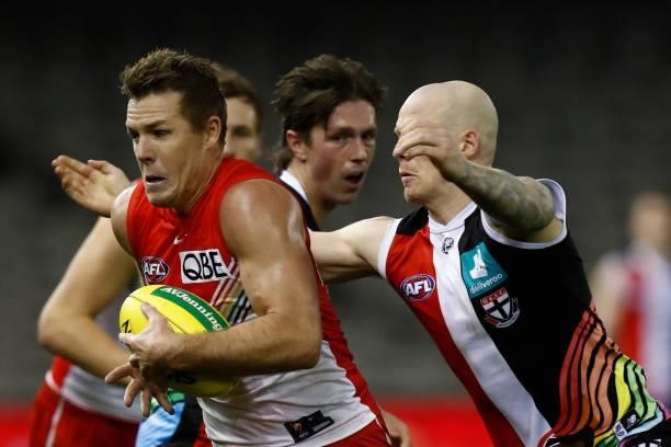 Zac Jones of the Saints tackles Luke Parker of the Swans during the round 21 AFL match between St Kilda Saints and Sydney Swans at Marvel Stadium on...