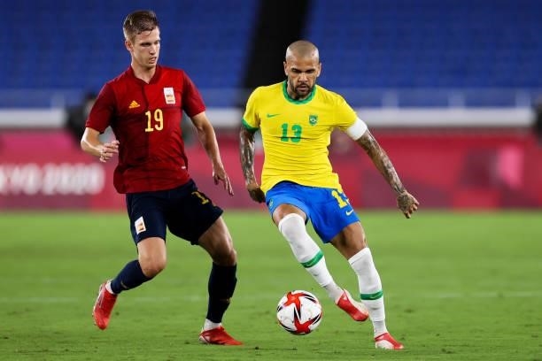 Dani Alves of Brazil competes for the ball with Dani Olmo of Spain during the Men's Gold Medal Match between Brazil and Spain on day fifteen of the...
