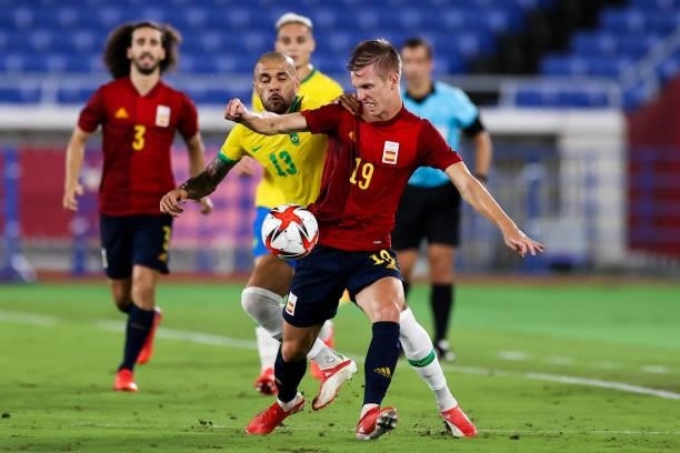 Dani Alves of Brazil competes for the ball with Dani Olmo of Spain during the Men's Gold Medal Match between Brazil and Spain on day fifteen of the...