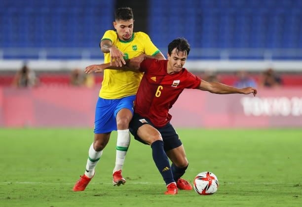 Guilherme Arana of Team Brazil battles for possession with Mikel Merino of Team Spain during the Men's Gold Medal Match between Brazil and Spain on...