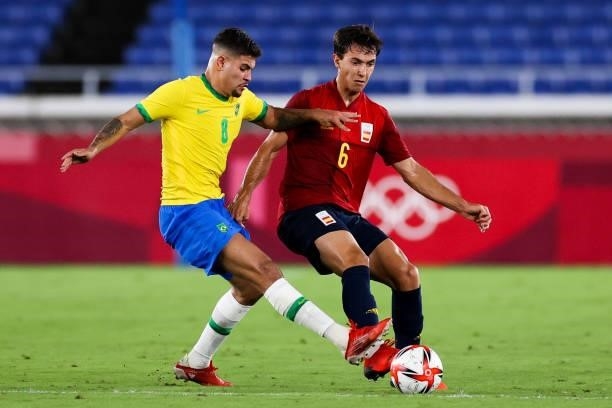 Bruno Guimaraes of Brazil competes for the ball with Martin Zubimendi of Spain during the Men's Gold Medal Match between Brazil and Spain on day...