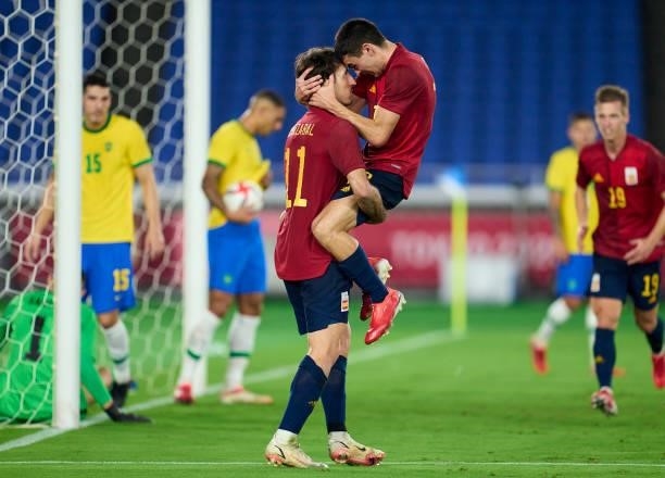 Mikel Oyarzabal of Team Spain celebrates with Pedro Gonzalez Lopez 'Pedri' of Team Spain scoring his team's first goal during the Men's Gold Medal...