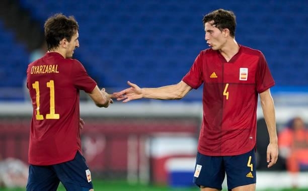 Mikel Oyarzabal of Team Spain celebrates with Pau Torres of Team Spain scoring his team's first goal during the Men's Gold Medal Match between Team...