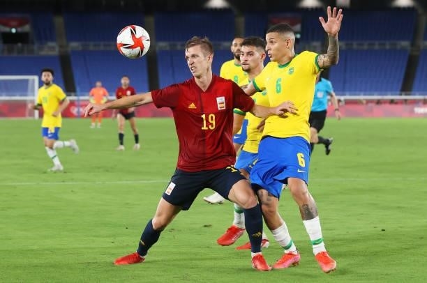 Dani Olmo of Team Spain battles for possession with Guilherme Arana of Team Brazil during the Men's Gold Medal Match between Brazil and Spain on day...