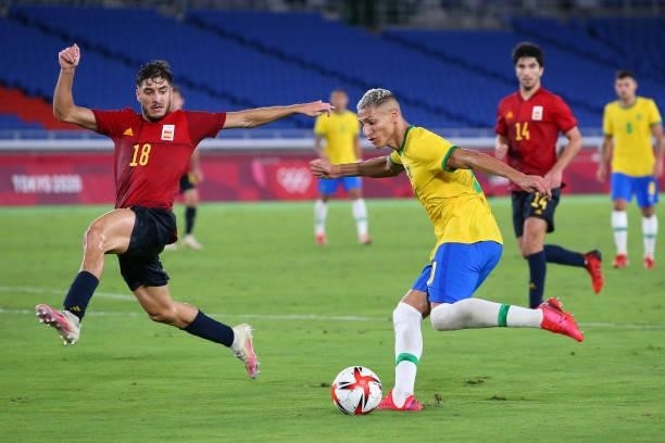 Richarlison of Team Brazil crosses the ball whilst under pressure from Oscar Gil of Team Spain during the Men's Gold Medal Match between Brazil and...