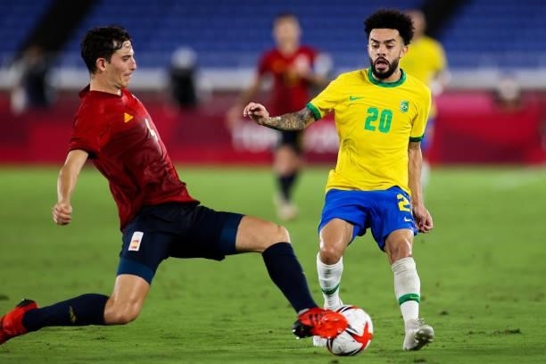 Claudinho of Brazil competes for the ball with Pau Torres of Spain during the Men's Gold Medal Match between Brazil and Spain on day fifteen of the...