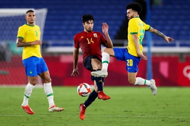 Claudinho of Brazil competes for the ball with Carlos Soler of Spain during the Men's Gold Medal Match between Brazil and Spain on day fifteen of the...
