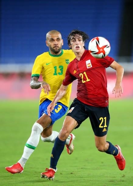 Bryan Gil of Team Spain battles for possession with Dani Alves of Team Brazil during the Men's Gold Medal Match between Brazil and Spain on day...