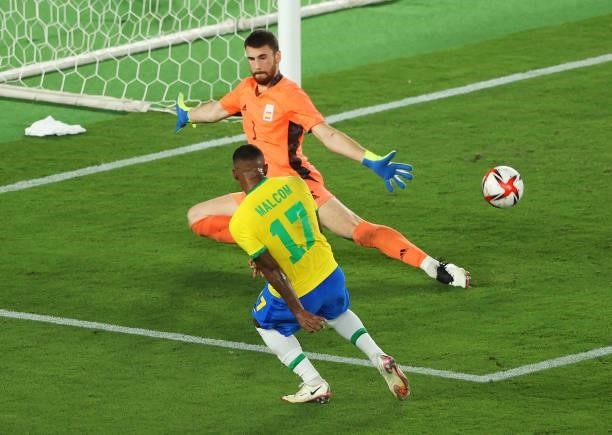 Malcom of Team Brazil scores their side's second goal past Unai Simon of Team Spain during the Men's Gold Medal Match between Brazil and Spain on day...