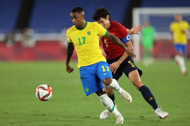 Malcom of Team Brazil battles for possession with Jesus Vallejo of Team Spain during the Men's Gold Medal Match between Brazil and Spain on day...