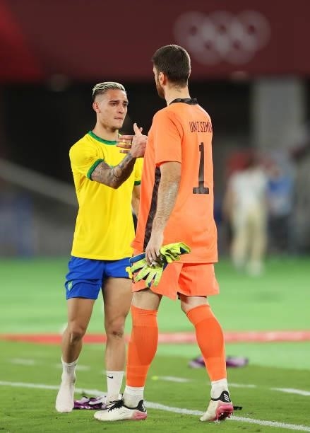 Antony of Team Brazil reacts as he shakes hands with Unai Simon of Team Spain following victory in the Men's Gold Medal Match between Brazil and...