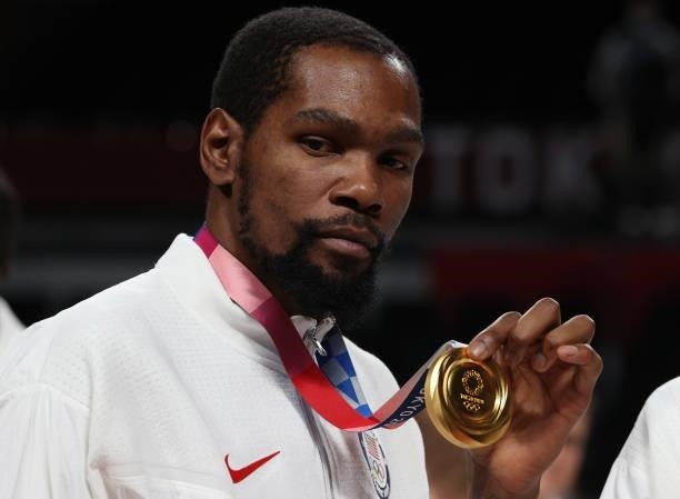 Kevin Durant of Team United States poses for photographs with his gold medal during the Men's Basketball medal ceremony on day fifteen of the Tokyo...