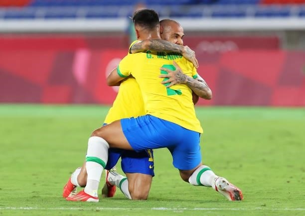 Gabriel Menino and Dani Alves of Team Brazil celebrate their side's victory after the Men's Gold Medal Match between Brazil and Spain on day fifteen...