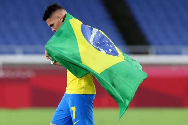 Paulinho of Team Brazil celebrates their side's victory with a flag of Brazil after the Men's Gold Medal Match between Brazil and Spain on day...