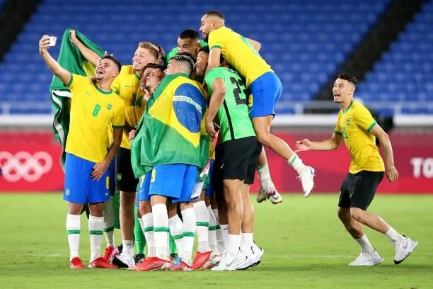 Bruno Guimaraes of Team Brazil takes a group photograph as they celebrate their side's victory after the Men's Gold Medal Match between Brazil and...
