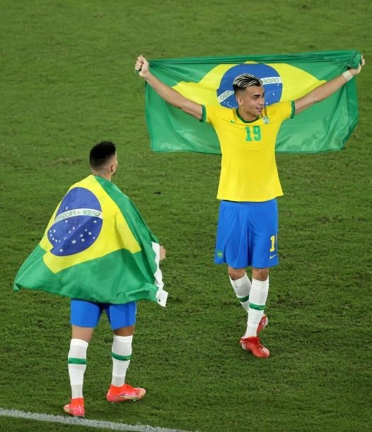Reinier of Team Brazil celebrates their side's victory with a flag of Brazil after the Men's Gold Medal Match between Brazil and Spain on day fifteen...