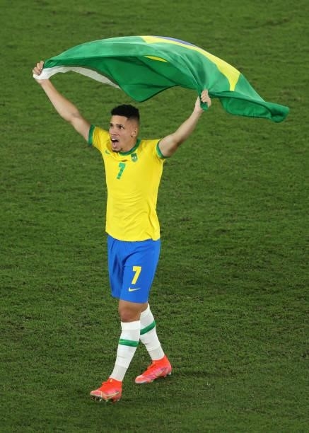 Paulinho of Team Brazil celebrates their side's victory with a flag of Brazil after the Men's Gold Medal Match between Brazil and Spain on day...
