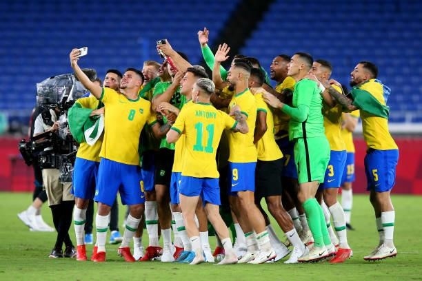 Bruno Guimaraes of Team Brazil takes a group photograph as they celebrate their side's victory after the Men's Gold Medal Match between Brazil and...