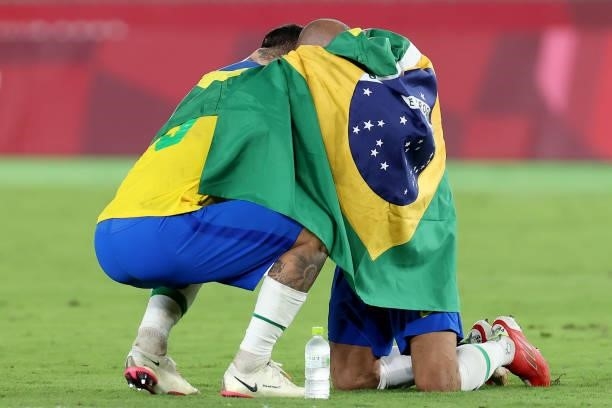 Luiz Douglas and Dani Alves of Team Brazil celebrate their side's victory after the Men's Gold Medal Match between Brazil and Spain on day fifteen of...