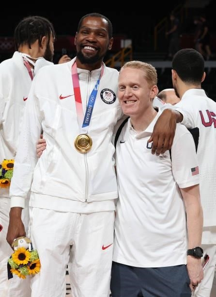 Kevin Durant celebrates with a Team United States basketball staff member during the Men's Basketball medal ceremony on day fifteen of the Tokyo 2020...