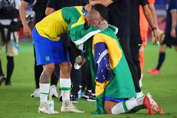 Luiz Douglas and Dani Alves of Team Brazil celebrate after defeating Team Spain 2-1 to win the men's gold medal match between Team Brazil and Team...