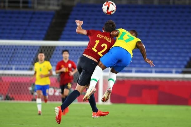 Eric Garcia of Team Spain and Malcolm of Team Brazil jump for possession in the first period of extra time during the men's gold medal match between...